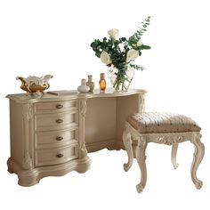 an antique vanity and stool with flowers on it