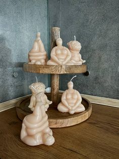 three candles sitting on top of a wooden stand