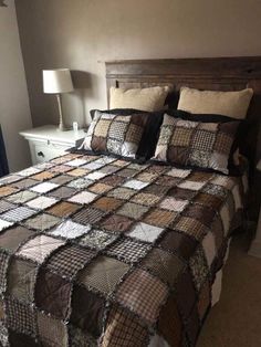 a bed with brown and white quilts in a bedroom