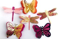 several different colored butterflies on a white background