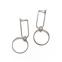 Very lightweight and easy to wear everyday hoop earrings with a circle drop. Made with 20 gauge wire - about .8mm thick. A perfect addition to a minimalist capsule wardrobe. Dainty enough to wear on a daily basis but dressy enough for a special occasion.These minimalist hoops are available in 14k gold fill or sterling silver - about 2" long. Size may vary slightly due to the handmade nature of these earrings. See photos provided on ear for scale. Please note these earrings are handmade to order Minimalist Hoop Earrings For Everyday, Minimalist Metal Hoop Earrings, Minimalist Small Hoop Earrings In Metal, Minimalist Metal Hoop Earrings For Everyday, Minimalist Dangle Hoop Earrings, Minimalist Hoop Pierced Earrings, Minimalist Hypoallergenic Dangle Hoop Earrings, Minimalist Paperclip Hoop Earrings For Gift, Minimalist Everyday Earrings With Lever Back