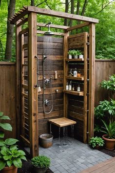 an outdoor shower in the middle of a garden with potted plants and greenery