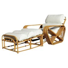 a chair and ottoman made out of bamboo with white cushions on the back, sitting next to each other