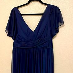 a blue dress hanging on a hanger