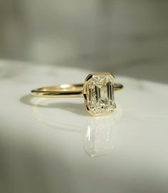 a close up of a diamond ring on a table