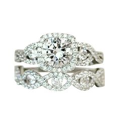 a white gold ring with an oval diamond in the center and two rows of diamonds around it