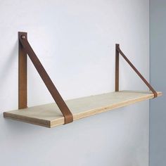 a wooden shelf mounted to the side of a wall