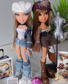 two dolls are posed next to each other