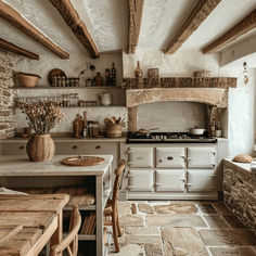 an old fashioned kitchen with stone floors and exposed beams