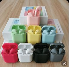 an assortment of airpods sitting on top of a wooden table