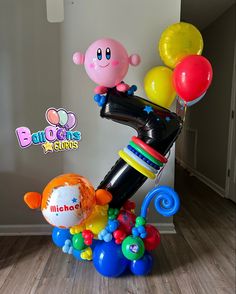 a bunch of balloons are in the shape of a rocket ship and an animal balloon