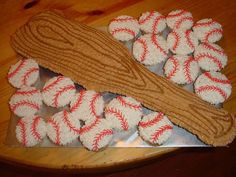 some baseballs are sitting on a metal tray with wood strips and rope around them