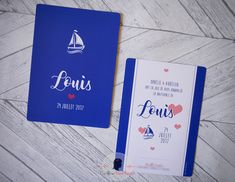 two blue notebooks sitting on top of a wooden floor next to an envelope with the word louis written in french