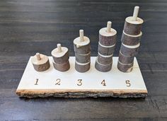 a set of wooden pegs sitting on top of a piece of wood with numbers