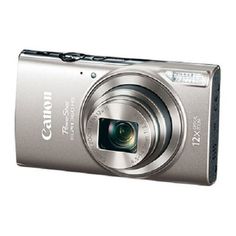 a silver digital camera sitting on top of a white surface