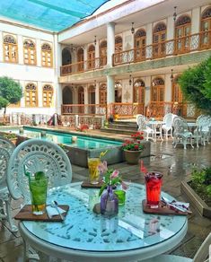 an outdoor dining area with tables and chairs