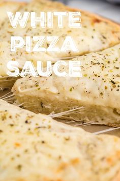 white pizza sauce is on top of the cheese and herbs covered pizza crusts that have been cut in half