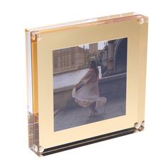 a glass photo frame with a woman in a dress