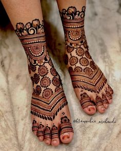 the feet are decorated with henna designs