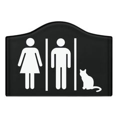 a black and white bathroom sign with a cat sitting next to it