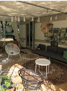 an outdoor living area with couches, tables and chairs