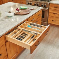 an open drawer in the middle of a kitchen