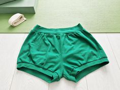 These are the so-called Pune pants or yoga bloomers. Those of the yogis who practice according to the Iyengar yoga tradition know about these shorts very well! Where did they come from? Traditionally, men in India wore the dhoti (a fabric wrap around the waist and legs) for yoga. The few women who practiced wore the nine-yard sari. Both could be complex to wrap and bulky to wear. When Western women began to come to India in the 1960s, they wore stretch pants and t-shirts. Guruji brought two pairs of stretch trousers back from Europe for Geeta, but these were not generally available to Indian women who continued to wear traditional garments such as long skirts, blouses with buttons up the front or the shalwar kameez. Some even borrowed trousers from male relatives. According to Geeta, what Relaxed Fit Yoga Athletic Shorts, Cotton Athletic Shorts For Yoga, Green Casual Athletic Shorts For Yoga, Casual Shorts For Pilates With Short Leg, Casual Shorts For Pilates, Casual Pilates Shorts, Casual Green Athletic Shorts For Yoga, Green Yoga Shorts, Summer Yoga Cotton Athletic Shorts