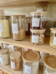 jars filled with different types of food sitting on top of a shelf in a store