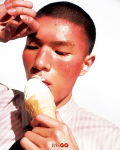 a young man is eating an ice cream cone