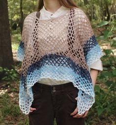 A crochet poncho is the colors of a beach and ocean wave, Made with 100% acrylic yarn in a mesh stitch, it's a perfect accessory for a summer cover-up, or a sea witch fantasy costume for Ren Faire! It's 11 inches from the neckline at the shortest point, and 22 inches from the neck at the longest point. Care Instructions: Machine wash and dry warm, do not iron or bleach. Pattern by: Crazy Cool Crochet Sheepberry's Sustainability Practices -Used or discounted yarn (when possible) -Making use of all fiber scraps -Recycled and reused packaging Hand Knitted Bohemian Poncho For Beach, Bohemian Hand Knitted Poncho For Beach, One Size Hippie Crochet Poncho, Bohemian Crochet Poncho In Acrylic Yarn, Bohemian Open Knit Cover-up, One Size Yarn Poncho For The Beach, Beach Crochet Top With Open Knit, Beach Crochet Top In Open Knit Yarn, One-size Crochet Poncho For Festivals