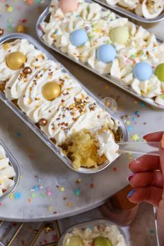 a person is holding a spoon with some cake in it and sprinkles on the table