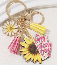 a sunflower keychain with happy mother's day written on it