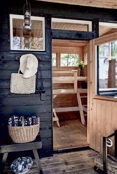 the inside of a cabin with wooden floors and walls, including a door that leads to an outside sauna