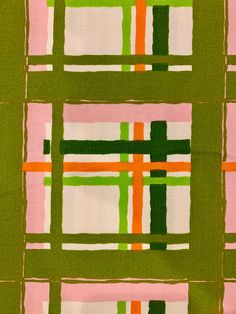 a green and pink checkered fabric with squares