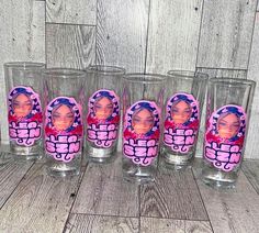 six shot glasses with pictures of barbie dolls on them