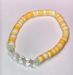 Cute yellow and white beaded bracelet. These are high quality handmade bracelets. They are made with an elastic string so will fit lots of sizes. They are around 6.75 inches. Please note that each braclet will have a very similar beading pattern but not exactly identical. Yellow Bracelets With Colorful Beads, Yellow Bracelets With Colorful Round Beads, Yellow Beaded Friendship Bracelets With Round Beads, Yellow Beaded Friendship Bracelets, Yellow Hand-strung Friendship Bracelets, Yellow Friendship Bracelets With Letter Beads, Yellow Hand-strung Friendship Bracelet, Yellow Hand-strung Friendship Bracelets With Round Beads, Yellow Beaded Bracelets With Large Beads For Gifts