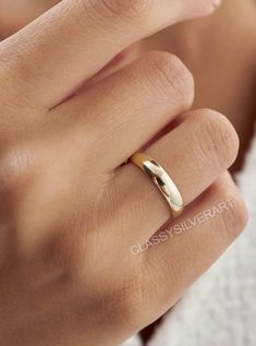 a woman's hand with a gold ring on it