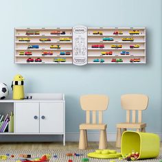 two children's toys are sitting on the floor in front of a book shelf