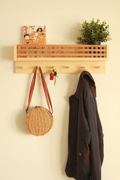 a coat rack and purse hanging on a wall