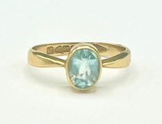 For your consideration is this   solitaire oval facet cut Aquamarine stone set in a 18kt gold white gold setting  the size of the ring is 6 1/2 stone.   is 6mm x 8mm inside is marked 18  it has English Markings  with makers mark W N  weight is 2.46 grams the main stone is facet cut rectangle shape  12 mm x 10mm height of 3mm  the ring is in good condition, Modern 14k Gold Oval Topaz Ring, Modern Oval Birthstone Ring For Formal Occasions, Oval Blue Sapphire Ring Hallmarked, Modern Oval Sapphire Birthstone Ring, Oval Yellow Gold Topaz Ring With Bezel Setting, Oval Blue Topaz Ring With Bezel Setting, Oval Topaz Ring In 14k Gold With Bezel Setting, Classic Oval Topaz Ring With Bezel Setting, Oval Topaz Ring For Formal Occasions