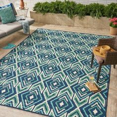 a blue and green area rug in the middle of a patio