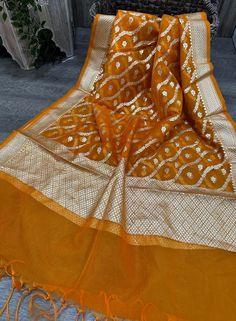 Lightweight organza Banarsi handloom dupatta with white gold zari. Color-Orange Note : Slight imperfections in zari weaving might be present, these are characteristics of handlooom weaving, and are not defects. Orange Tissue Silk Dupatta With Zari Work, Silk Dupatta With Zari Work In Orange, Orange Chanderi Dupatta With Cutdana, Orange Chanderi Dupatta With Cutdana Details, Orange Tissue Silk Traditional Wear With Dupatta, Orange Tissue Silk Dupatta, Orange Cutdana Chanderi Dupatta, Orange Bollywood Style Tissue Silk Dupatta, Orange Tissue Silk Dupatta For Diwali