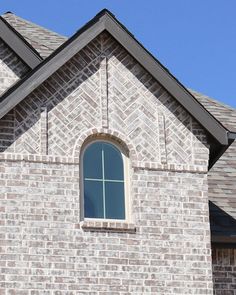 a large brick building with a clock on it's face and two windows in the front