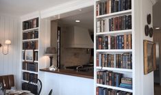 the bookshelves are filled with many different types of books in this kitchen area