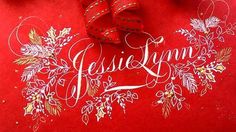 a red bag with a ribbon on it and some decorations around the bottom that says jesuslynn