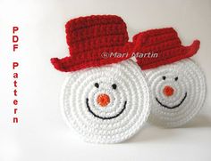 two crocheted snowmen wearing red hats