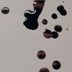 several drops of water floating on top of each other in the air with white background