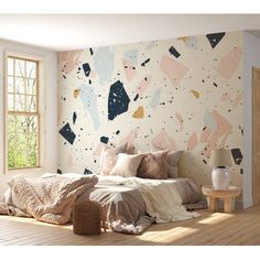 a bedroom with a large bed in front of a colorful wallpapered wall next to a window