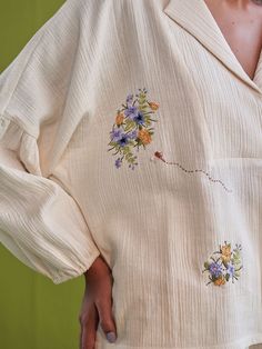 VALUES Handcrafted Organic Fair Minimal Waste CURATOR'S NOTE Relaxed fit, long puff sleeve, v-neck shirt crafted in double gauze organic cotton fabric that's embroidered with botanic-inspired motifs. This classic, staple shirt is so versatile and can be endlessly mixed-and-matched to create a fresh outfit each time you put it on. Techniques Used: Hand Embroidery. THE DESIGNER STORY "Sui" is the new endeavor of the brand Sue Mue. A budding label, that aims to weave together our love for travel an Suit Pattern, Fresh Outfits, Hand Embroidery Flowers, Kurta Designs Women, Eco Friendly Clothing, Embroidery Suits, Gauze Fabric, Heart Shirt, Double Gauze