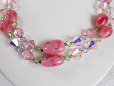 "This Vintage 2 STRAND BEADED Necklace was created using PINK hand painted ART Beads & colorful crystal beads. The clasp was repurposed as well. Measuring approximately 18\" ( see photos for sizes & details ) This unique necklace is in VERY GOOD VINTAGE CONDITION. Questions ? Please message me or call 1-207-865-6191." Pink Czech Glass Necklaces With Colorful Beads, Handmade Pink Crystal Beaded Necklaces, Handmade Pink Czech Glass Necklaces, Handmade Pink Czech Glass Necklace, Pink Beaded Czech Glass Necklace, Pink Czech Glass Beaded Necklace For Gifts, Pink Crystal Beaded Necklaces, Pink Glass Jewelry With Faceted Beads, Pink Czech Glass Necklaces With Faceted Beads